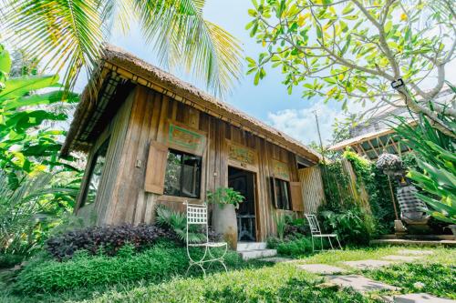 a small house in the middle of a garden at The Onion Collective in Ubud