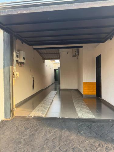 an empty hallway of a building with an open door at Vértice House 1 in Uberlândia