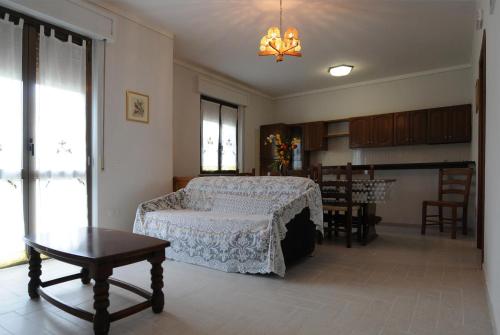 a bedroom with a bed and a table in it at L'Ortolano Apartments in Spoleto