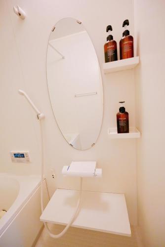 a bathroom with a mirror and a white sink at Yuki's house - Kyoto single-family house, 3 minutes to the nearest bus stop in Kyoto