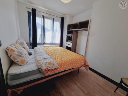 a bedroom with a bed with pillows on it at Duplex en Centre-Ville de Valenciennes Tout Inclus - FR-1-510-232 in Valenciennes