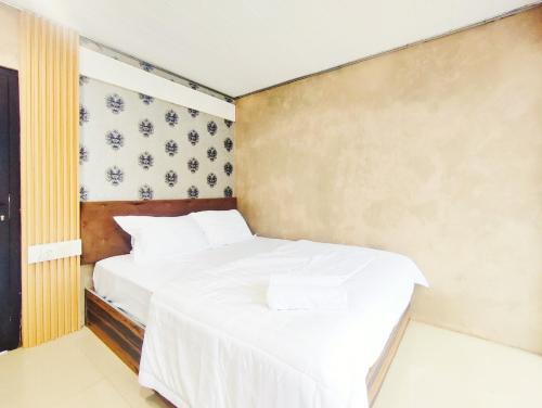 two beds in a small room with white sheets at Napoleon Hills Tambi Tea Gardens View RedPartner in Kejajar