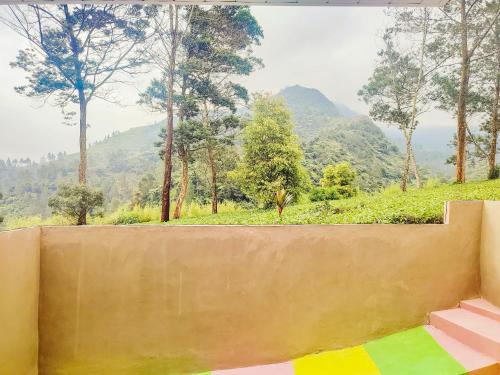 a concrete wall with a view of a mountain at Napoleon Hills Tambi Tea Gardens View RedPartner in Kejajar