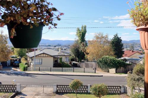 a house with a potted plant hanging over a street at Coleman Comfort Hub - close to City&Air port in Moonah