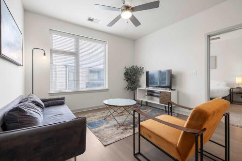a living room with a couch and a table at Modern Nulu 2BR CozySuites 10 in Louisville