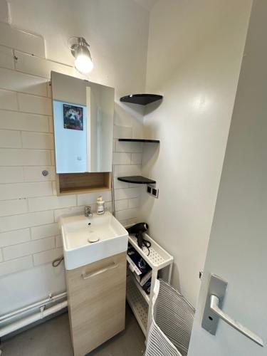 a small bathroom with a sink and a counter at Elegant 2 Bedroom Apartment with Free Parking Paris St-Denis by Immo Kit BNB in Saint-Denis