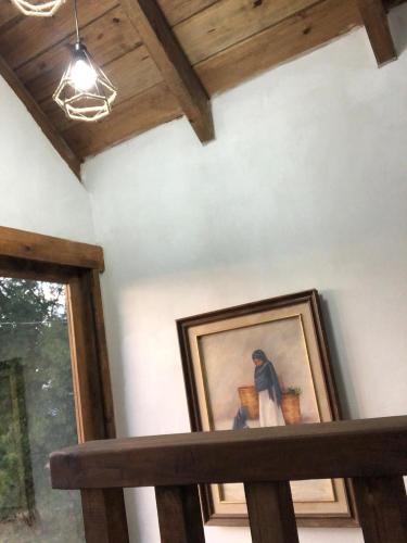 a picture of a painting on a wall in a room at Cabañas Las orquídeas in Huasca de Ocampo