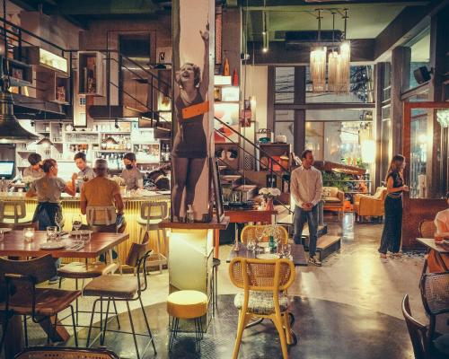 a restaurant with a statue of a woman on a table at Sacha's Hotel Uno in Bangkok