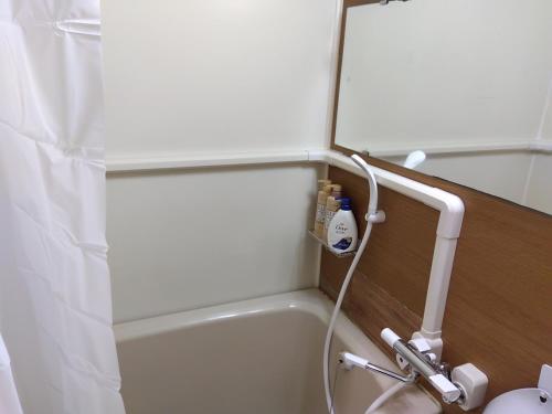 a bathroom with a shower and a bath tub with a shower at BetterЯ03青森橋本208号室 in Aoki