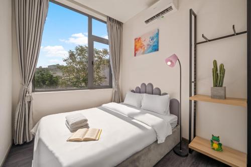 a bedroom with a large bed with a window at Hùng Villa 5br Full Ac Quite -Rooftop Pool- Bida- New in Da Nang