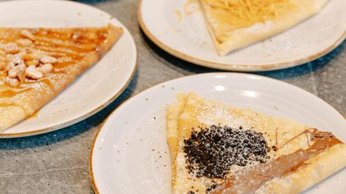 three plates of food on a table with pizza at voco Auckland City Centre by IHG in Auckland