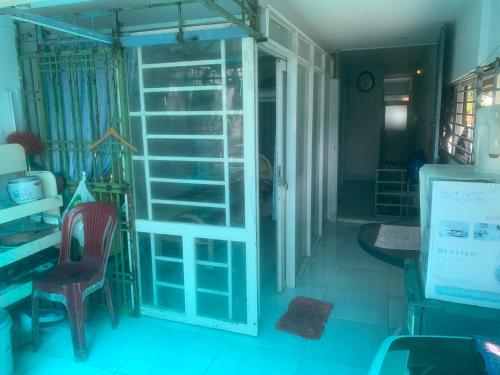 a room with a glass door and a table and chairs at Private Rooms-Low Price- Suburban of Saigon in Ho Chi Minh City