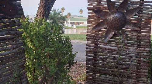 a statue of a sun on a stone wall at Jeffreys Bay - Life on the Canals in Jeffreys Bay