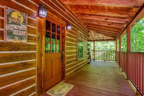 a porch of a log cabin with a door at Deer To My Heart, Free Attraction Tickets, Hot Tub, Arcade, Air Hockey, WIFI!!! in Sevierville