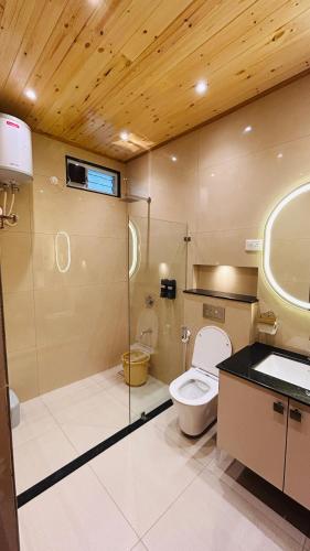 a bathroom with a toilet and a sink at Tamarind Tree Masinagudi in Masinagudi