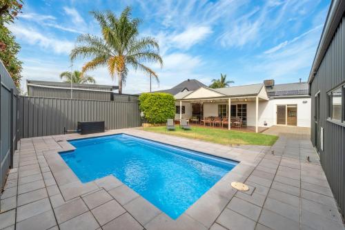a swimming pool in the backyard of a house at Coopers Cottage - Spacious Pool Escape with Studio in Woodville