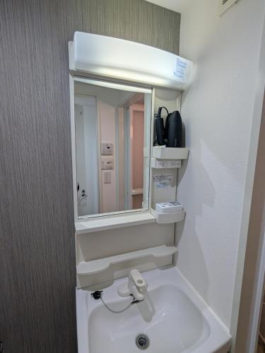 a bathroom with a sink and a mirror at 15min from Haneda Airport Cozy for 3 in Tokyo