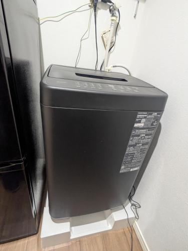 a computer monitor sitting on the floor next to a wall at 15min from Haneda Airport Cozy for 3 in Tokyo