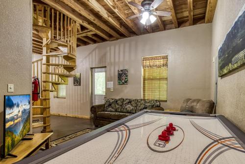 a living room with a ping pong table at Deer To My Heart, Free Attraction Tickets, Hot Tub, Arcade, Air Hockey, WIFI!!! in Sevierville
