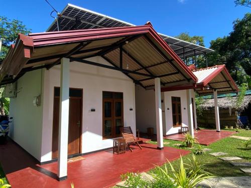 a small house with a pitched roof at TESHI SAFARI VILLA in Udawalawe