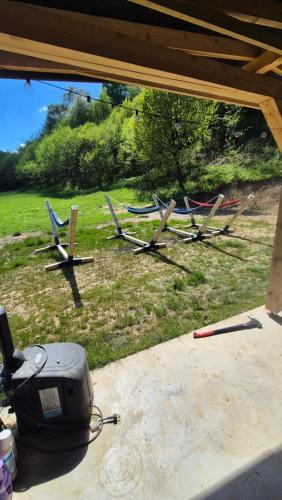 a group of chairs sitting on the grass at Cabana Bendis in Suciu de Sus