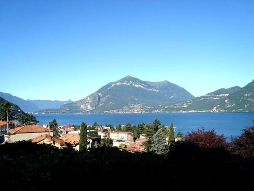 a town on the shore of a lake with mountains at Beautiful new apartment with private entrance and parking 5 min walking from center in Bellano