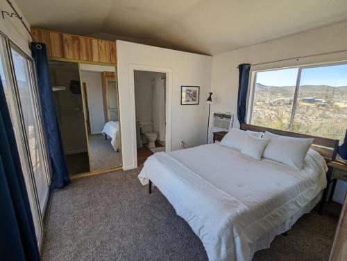 a bedroom with a large bed and a large window at The Loft in Meadview