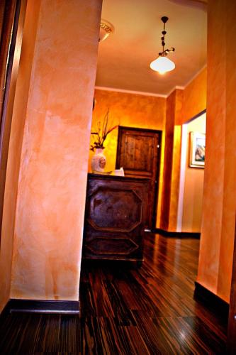 a hallway with a wooden floor and a room with a table at Monserrat in Castelmezzano