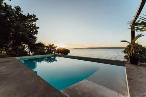a swimming pool with a view of the water at South Pacific Memories in Port Vila