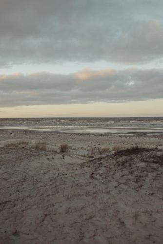 an empty beach with the ocean in the background at Berti in Upesgrīva