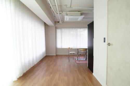 an empty room with a table and a window at Residence Unicorn in Seoul