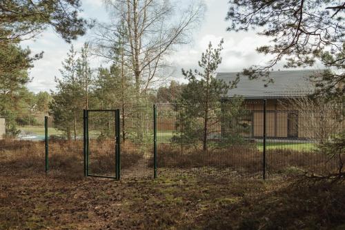 a batting cage in the yard of a house at Berti in Upesgrīva