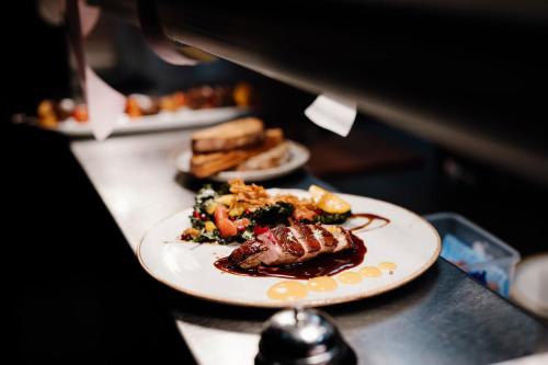 a table with two plates of food on it at The Remington Orange in Orange