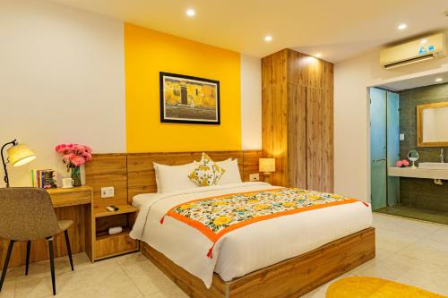 a bedroom with a bed and a desk and a sink at HA Gateway Inn Hoian Priavate Pool Villa in Hoi An