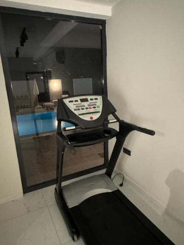 a treadmill in a room with a mirror at Begonvil Life in Gazipasa
