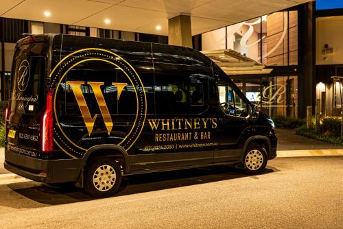 a black van parked in front of a building at The Remington Orange in Orange