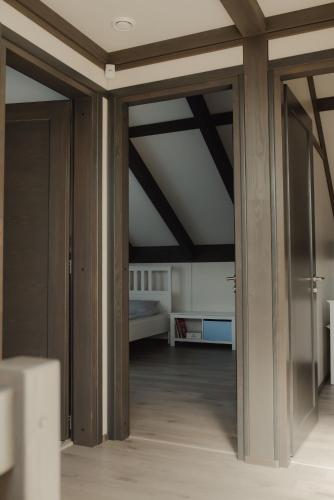 a room with a bed and a room with glass doors at Berti in Upesgrīva