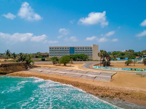 ein Gebäude am Strand neben dem Meer in der Unterkunft Gateway Diu in Diu