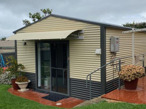 a house with a glass door in a yard at Vale Stay in McLaren Vale