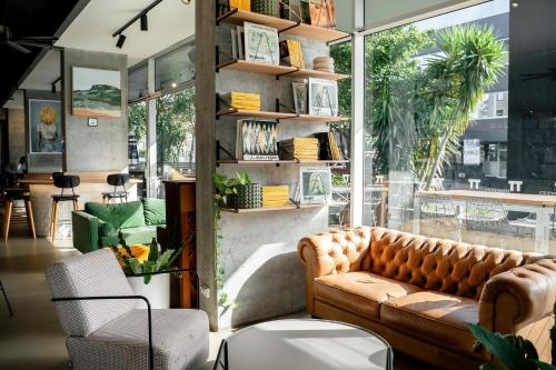 a living room with a couch in front of a window at Hotel TOTTO Wollongong in Wollongong