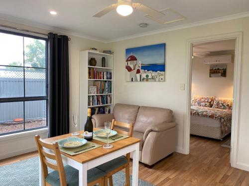 a living room with a table and a couch at Vale Stay in McLaren Vale