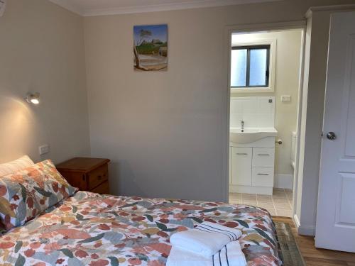 a bedroom with a bed and a sink and a window at Vale Stay in McLaren Vale