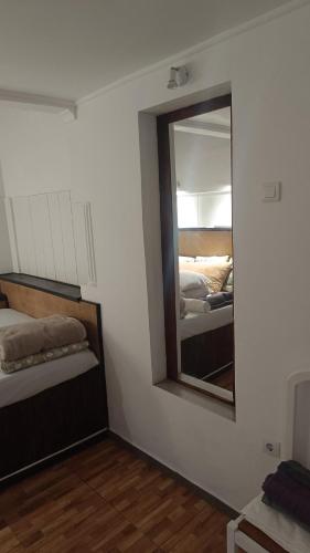 a mirror in a room with two beds in it at Ginjals 67 in Almargem do Bispo