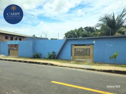a blue building on the side of a street at Hospedaria Caripí in Barcarena