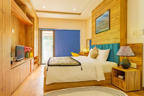 a bedroom with a large bed and a television at HA Gateway Inn Hoian Priavate Pool Villa in Hoi An