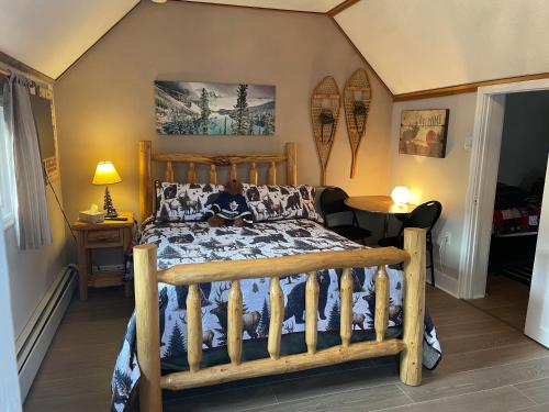 a man sitting on a bed in a bedroom at Holiday Lodge Cabins in Banff