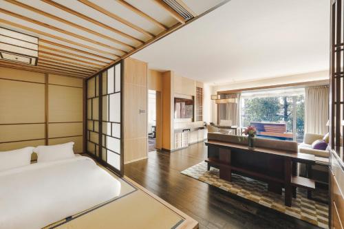 a bedroom with a bed and a desk at Four Seasons Hotel Kyoto in Kyoto