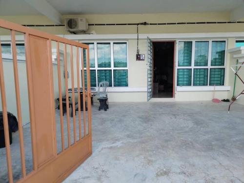 an empty room with a large room with windows at Aisya homestay Jeli Kelantan in Jeli
