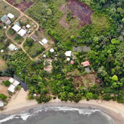 an aerial view of a beach with houses and trees at Atlantic view studio with Kitchen by Casa in Ebomé
