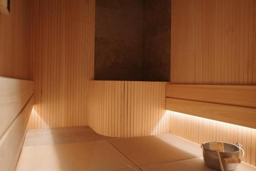 a sauna with a bowl on the floor of a room at etoe Hotel Shinjuku in Tokyo